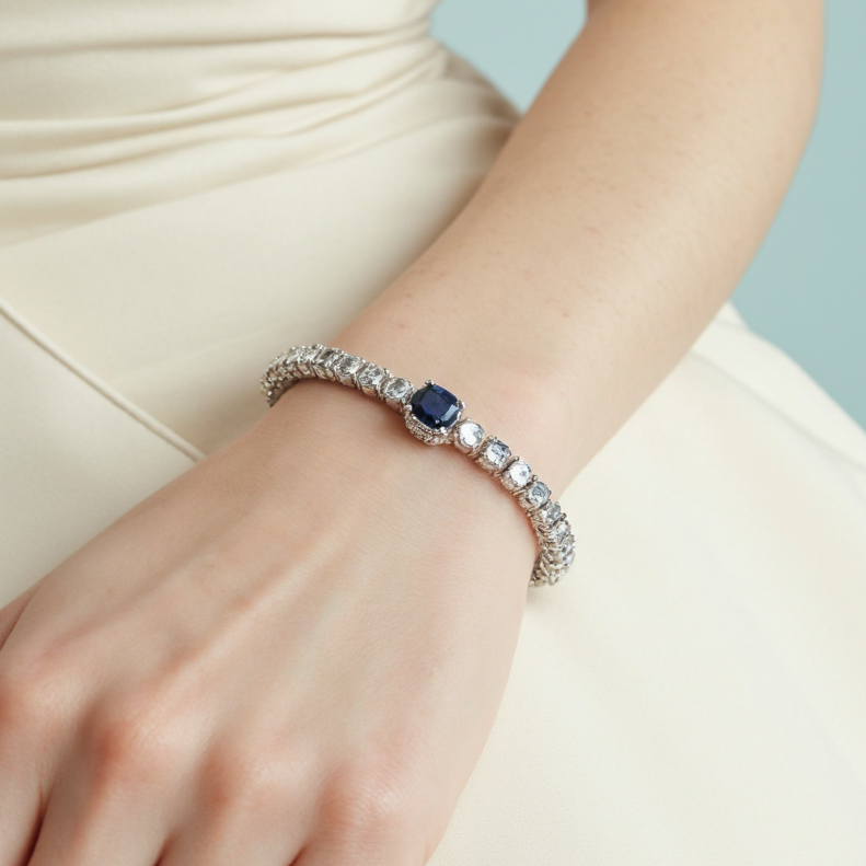 Delicate silver and gold bracelets displayed on a velvet tray