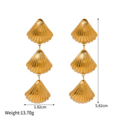 Gold ocean-inspired earrings with starfish and shell design