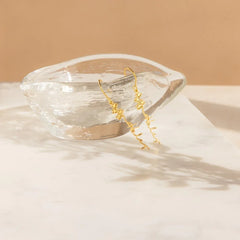 Copper and silver variants of FloraName earrings side by side