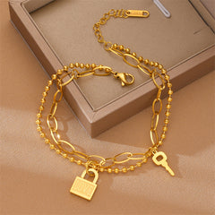 Stackable heart lock bracelet styled with other minimalist jewelry