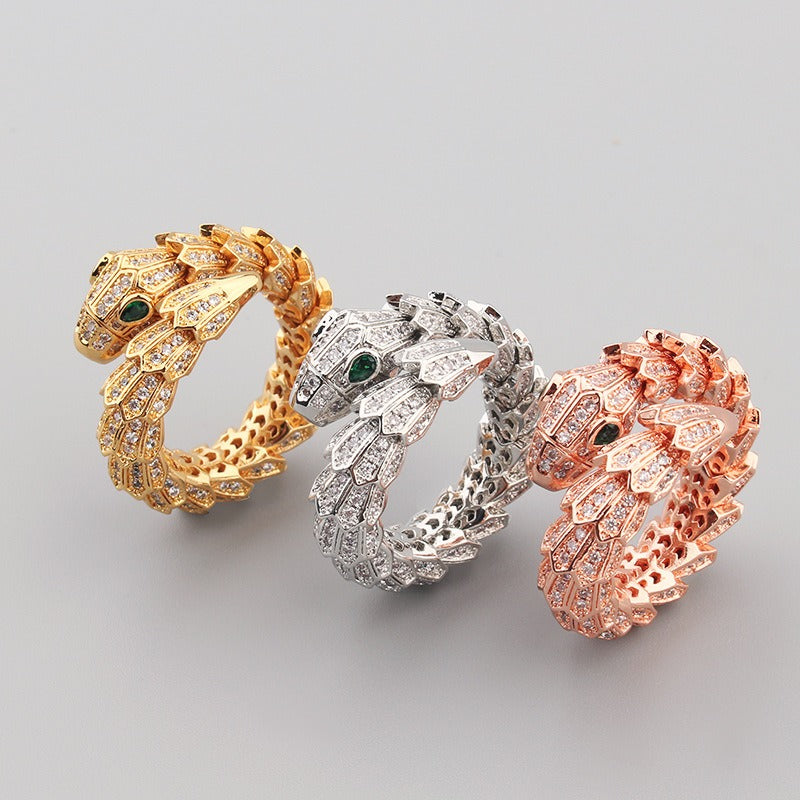 18K gold snake-shaped open ring with gemstone inlay on scales and eyes