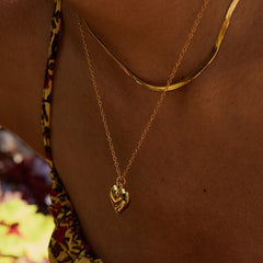 Layered gold necklace with heart and star pendant options