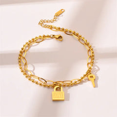 Elegant gold bracelet on wrist featuring simple heart-shaped lock
