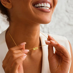 Model wearing custom name silver necklace with minimalist outfit