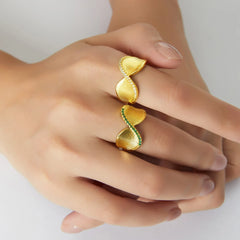 Close-up of smooth twist in gold ring with small diamond accent