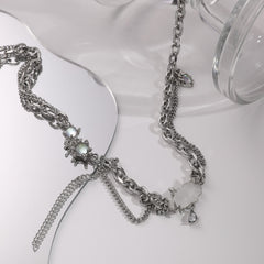 Side view of moonstone tassels hanging from cloud pendant under soft light