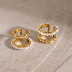 Double-layer earrings with pearl and zircon detailing on white background
