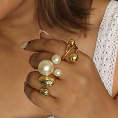Minimalist gold ring with sleek lines and sphere details