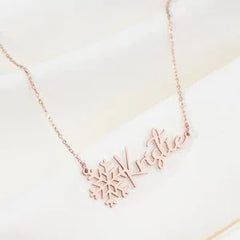 Close-up of engraved name on silver snowflake pendant necklace