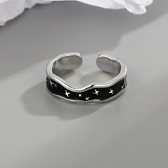 Side profile showing wave curve and star design on open ring