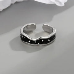 Side profile showing wave curve and star design on open ring