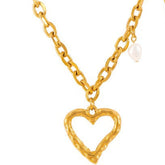 Model wearing delicate heart-shaped gold necklace with neckline focus