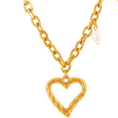 Model wearing delicate heart-shaped gold necklace with neckline focus