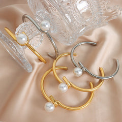 Model wearing minimalist twisted pearl gold bracelet with casual outfit