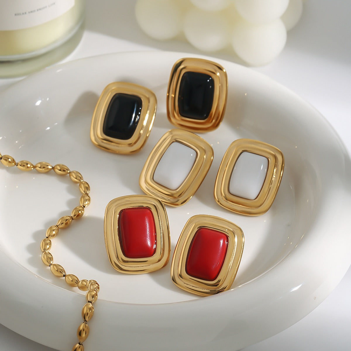 18K gold arc-angled rectangular earrings on white background