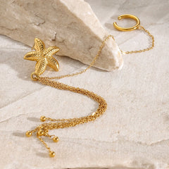 Mirella 18K gold starfish earrings with flowing tassel design on white background