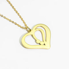 Model wearing silver heart necklace with personalized name detai