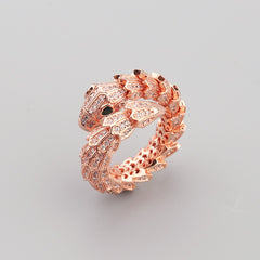 Side angle of serpent ring showing textured curves and gemstone shine