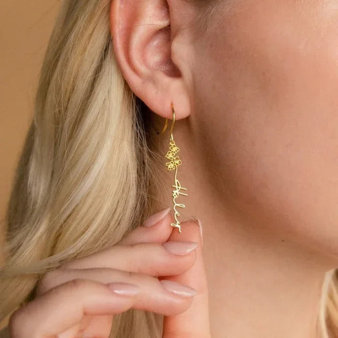 Model wearing personalized flower-shaped earrings with elegant styling