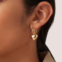 Model wearing Vivara earrings with swept hair and minimalist top
