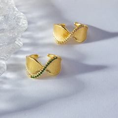 Side profile of gold twist ring showing elegant curve and diamond placement