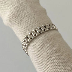 Side profile of link bracelet showing smooth edges and diamond accents