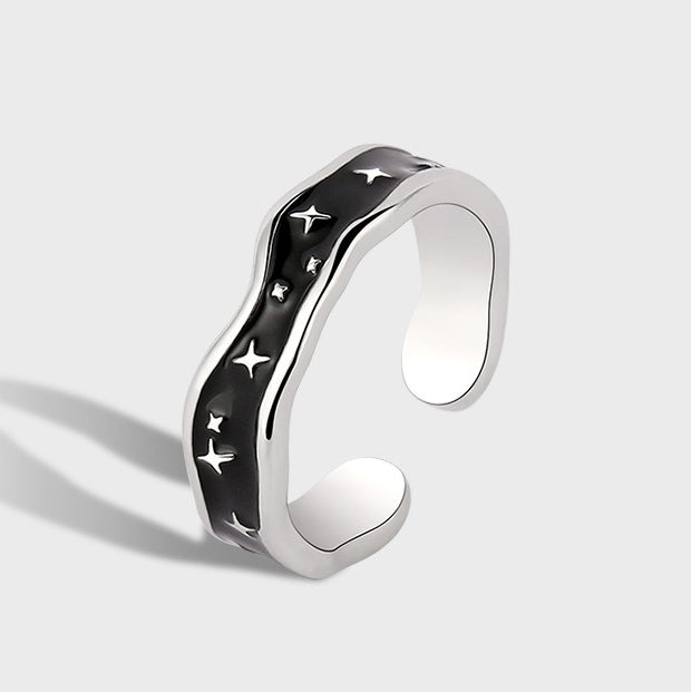 Platinum-plated open ring with wave line design and star accent