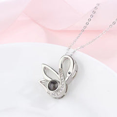 Swan-shaped gold necklace with diamond detailing and projection stone