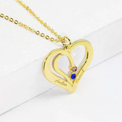 Close-up of engraved name on silver heart pendant necklace