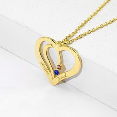 Model wearing silver heart necklace with personalized name detai