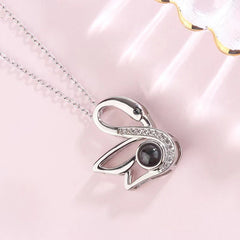 Personalized necklace projecting couple photo through light