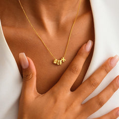 Model wearing custom name silver necklace with minimalist outfit