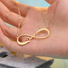 Side profile of silver infinity pendant showing engraved personalization