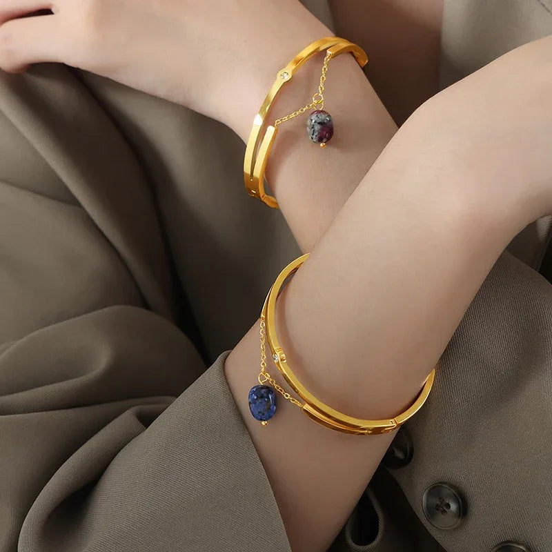 Model wrist wearing Lunaria bracelet styled with neutral tones