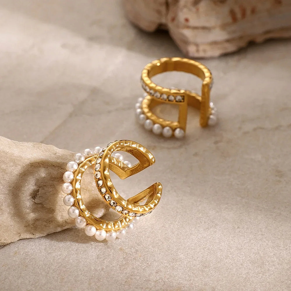 Close-up of 18K gold pearl and diamond earrings reflecting light luxury style