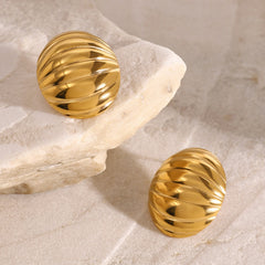 Minimalist oval-shaped 18K gold earrings with artistic detail