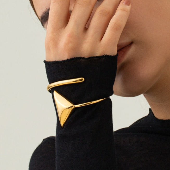 Geometric triangle and coil detailing on Golden Axis 18K gold bracelet
