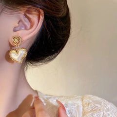 Elegant pearl heart earrings styled for romantic occasions