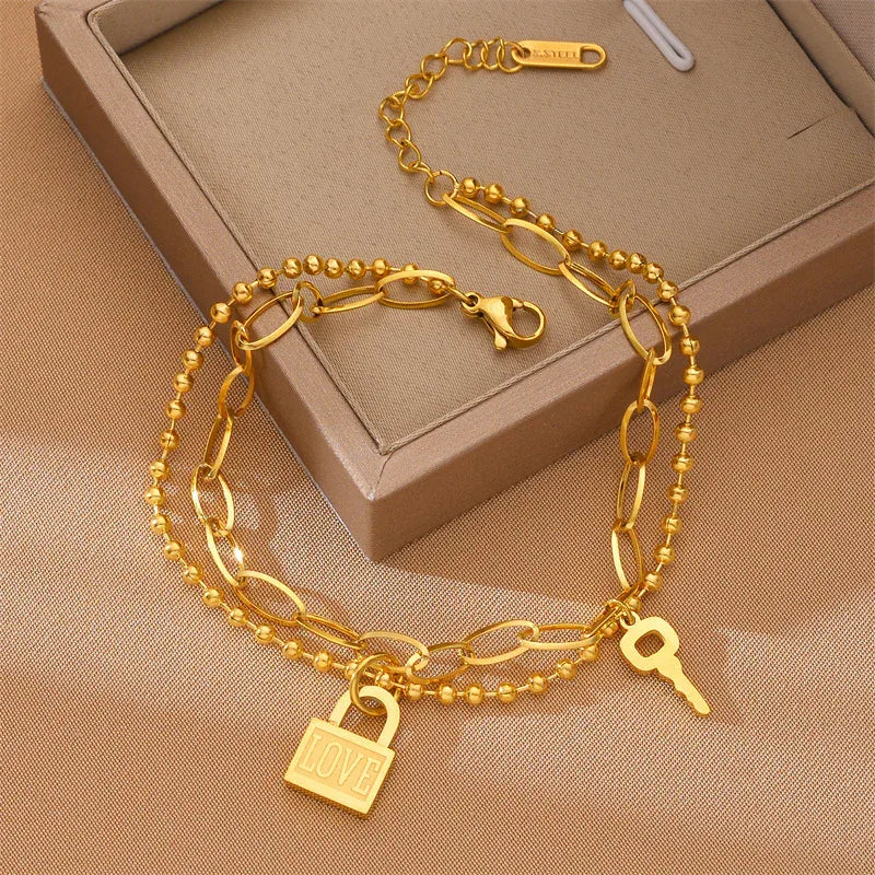Stackable heart lock bracelet styled with other minimalist jewelry