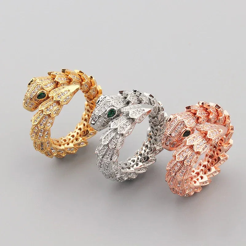 18K gold snake-shaped open ring with gemstone inlay on scales and eyes