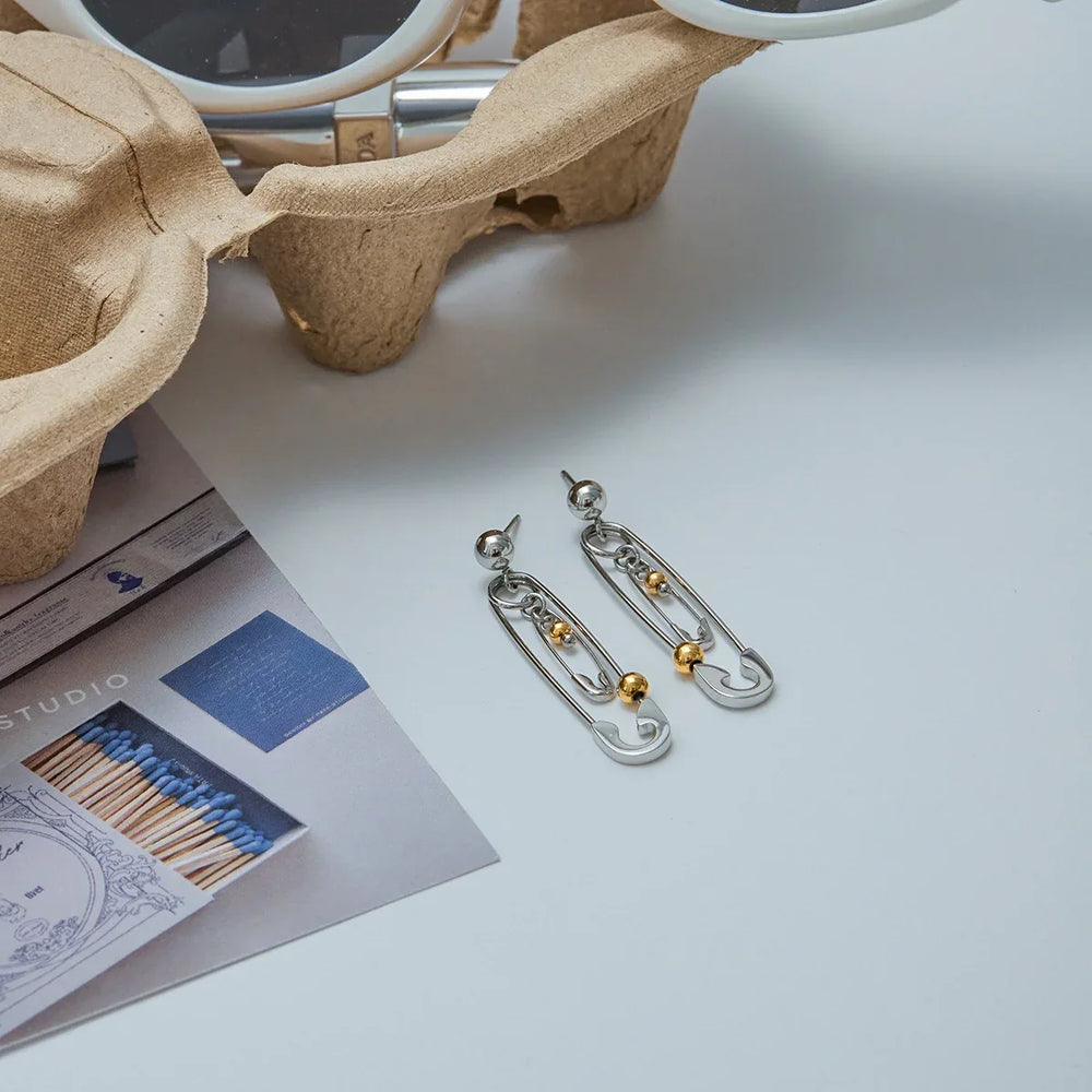 Gold and silver colorblock earrings in modern pin design