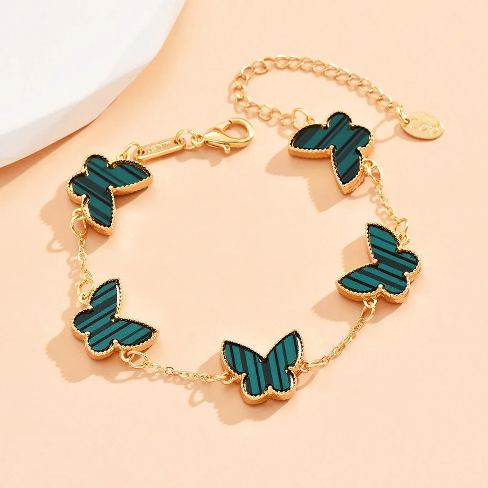 Wings of Fortune – 18K Gold Butterfly and Clover Pendant Bracelet