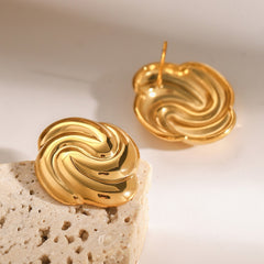 Detailed textured surface of geometric gold earrings