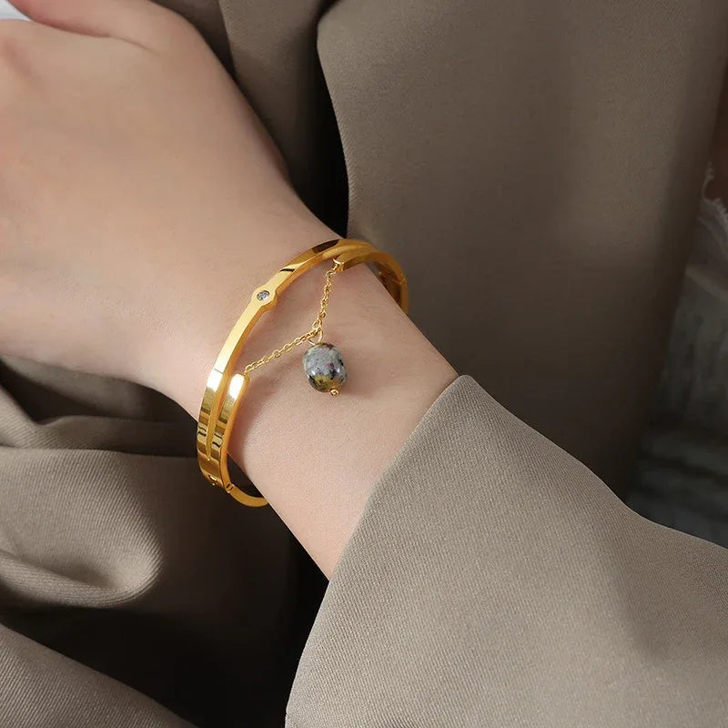 Flat lay of Lunaria bracelet with silk fabric and minimalist accessories

