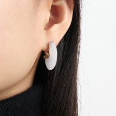 18K gold fan-shaped earrings styled with formal outfi