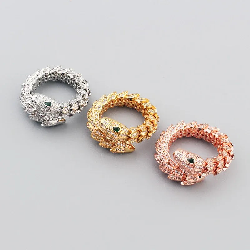 Model wearing snake ring with bold fashion outfit and layered jewelry