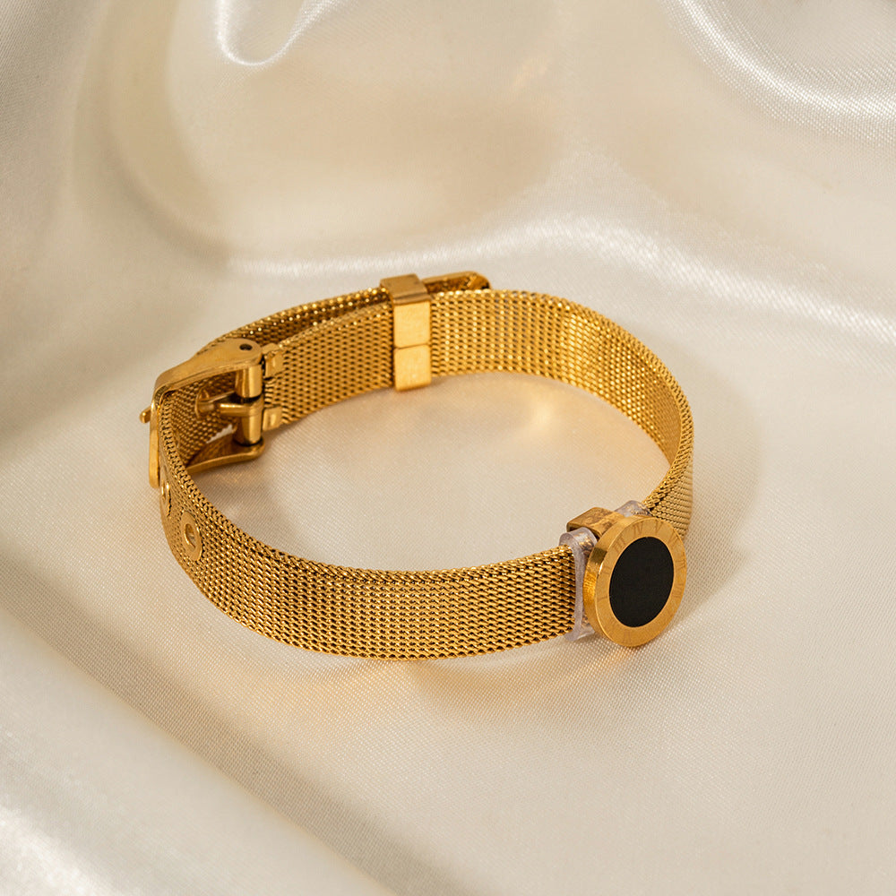 Black gemstone and engraved Roman numerals on vintage-style gold bracelet