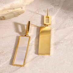 Gemstone detail set in polished rectangular gold pendant earrings