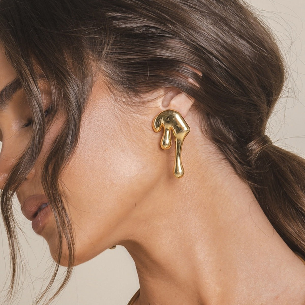 Side view showing the asymmetric curves of lava earrings