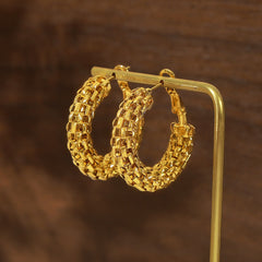 Eterna Loop 18K gold C-shaped minimalist earrings on white background